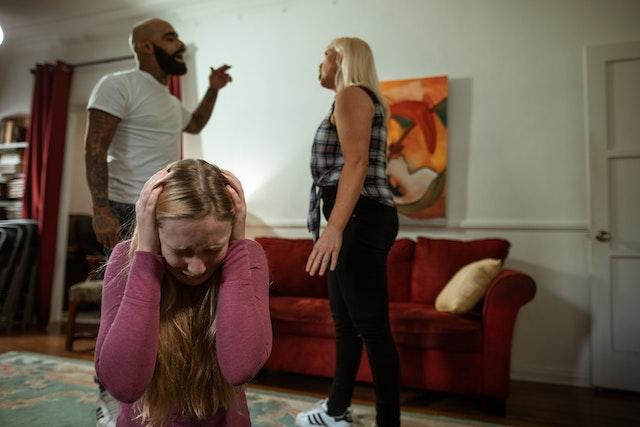 Parents arguing in front of their teenage daughter