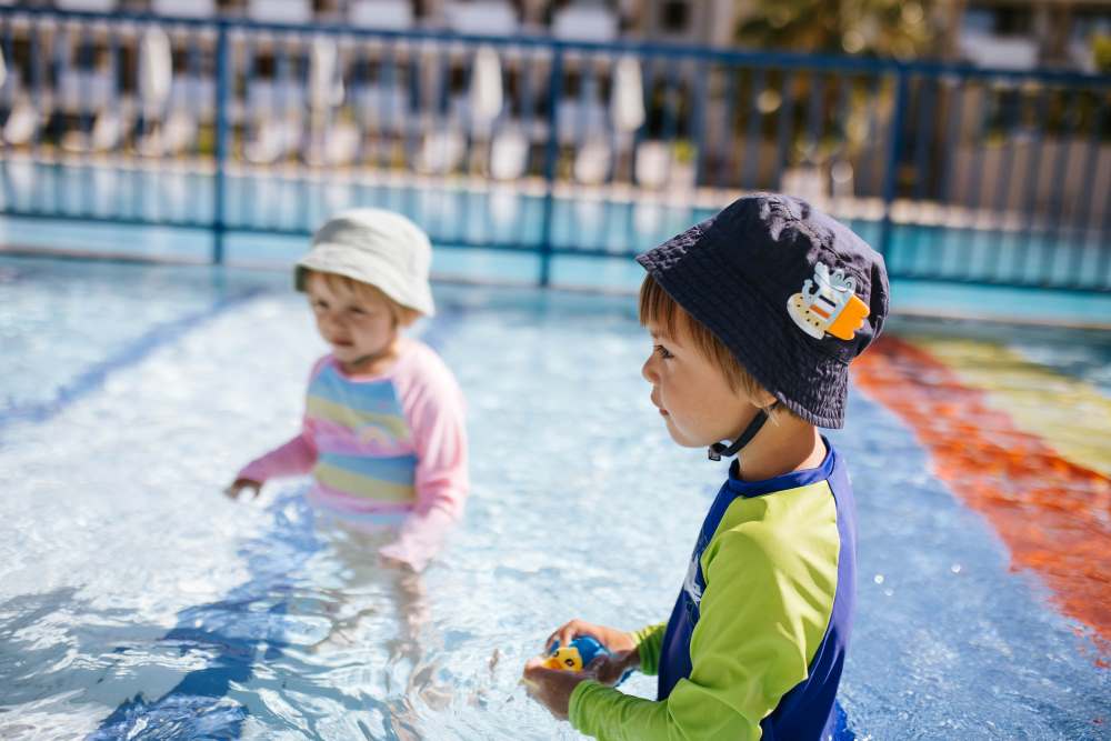 kids swimming in the sun