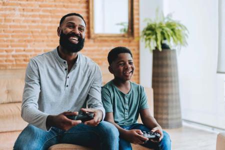 kid playing video games with dad