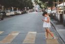 kid on a crosswalk with a phone