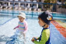 kids swimming in the sun